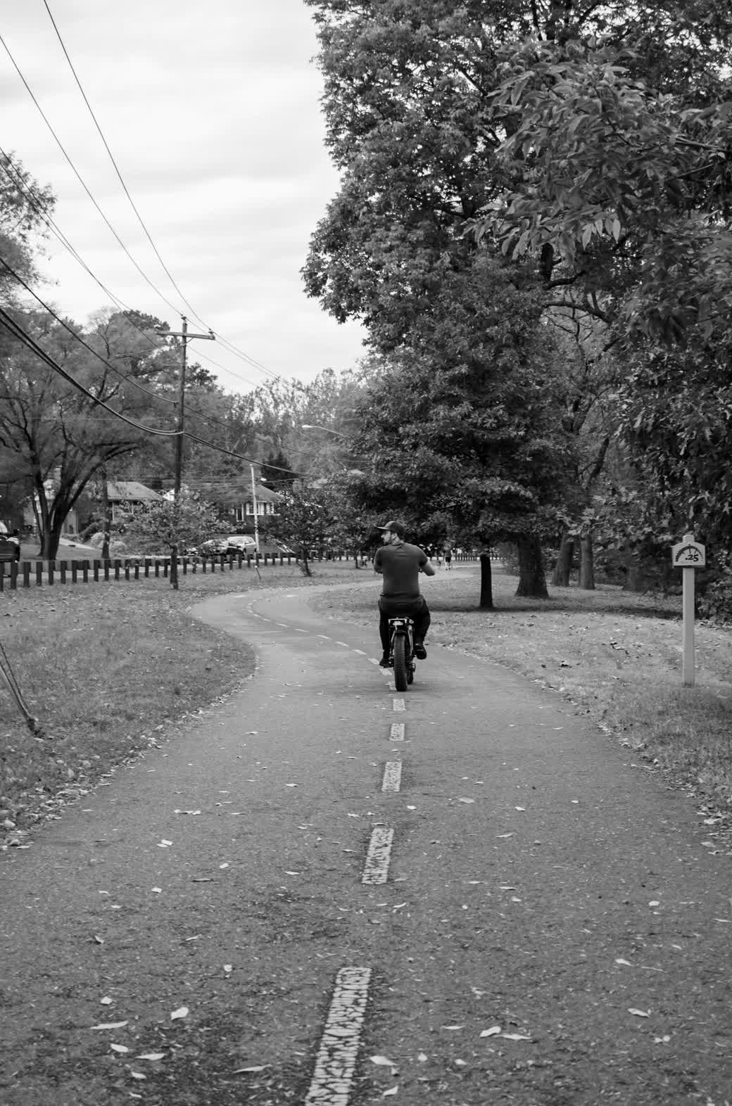 Rider on a Snapcycle fat-tire e-bike cruising an autumn park trail