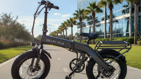 Snapcycle e-bike on a sunny city bike path beside a modern glass building