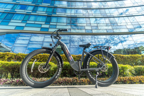 Snapcycle e-bike parked by a modern glass building in the city