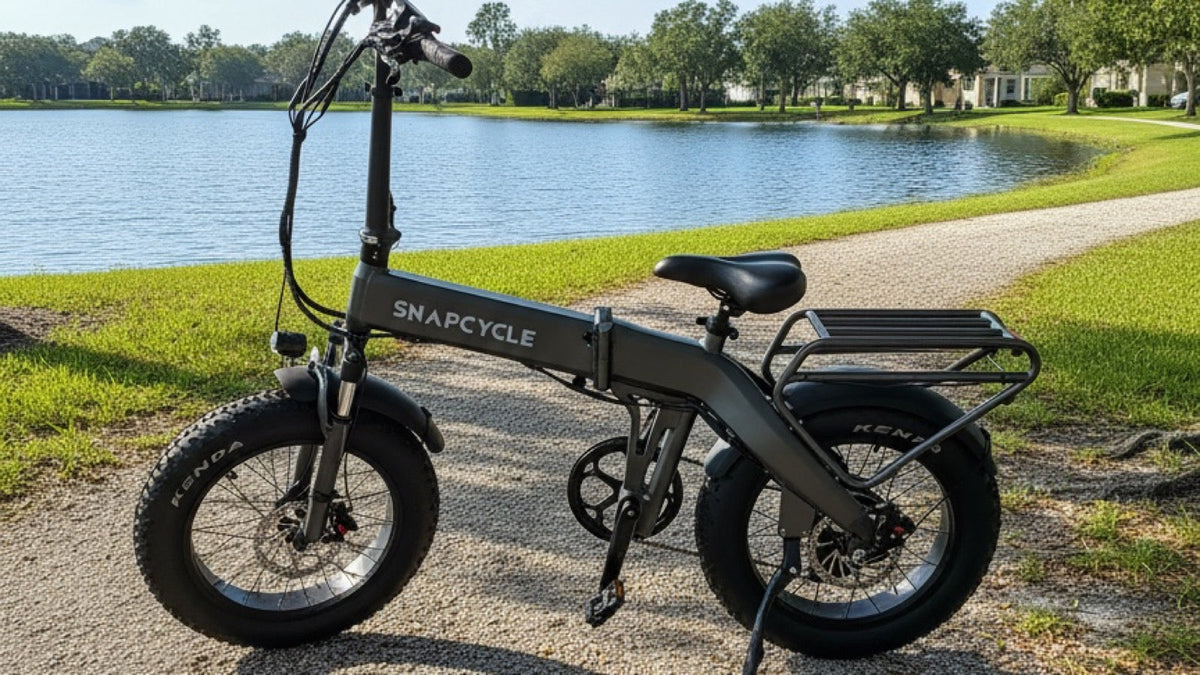 Snapcycle e-bike on a lakeside park path on a bright summer morning