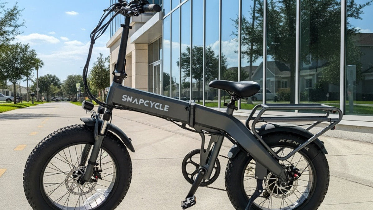 Snapcycle e-bike on a sunny city bike path beside a modern glass building