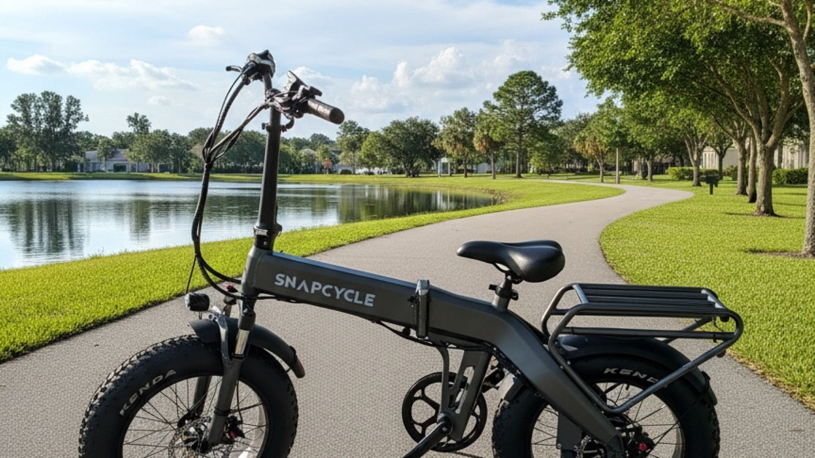 Snapcycle e-bike on a lakeside park path on a bright summer morning